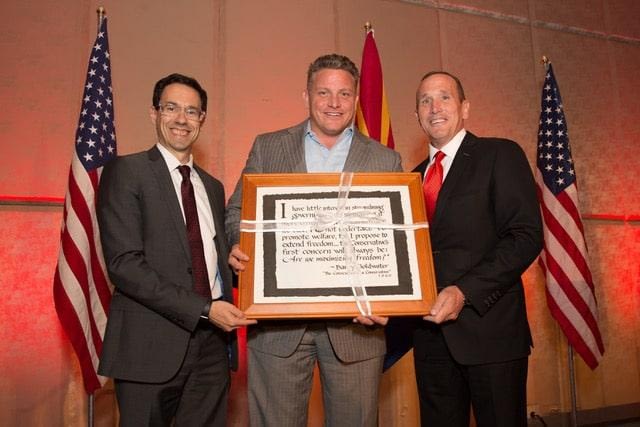 Kevin DeMenna and Arizona Chamber of Commerce & Industry President Glenn Hammer present a gift to outgoing Republican Party Chairman Robert Graham at the 2017 Republican Party Legislative Salute.