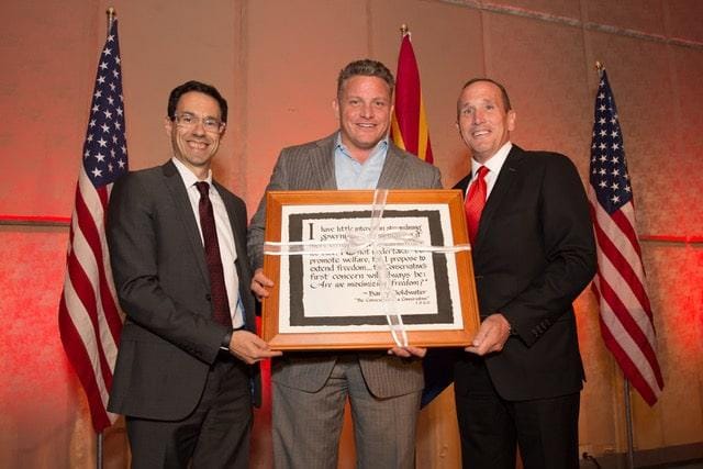 Kevin DeMenna and Arizona Chamber of Commerce & Industry President Glenn Hammer present a gift to outgoing Republican Party Chairman Robert Graham at the 2017 Republican Party Legislative Salute.